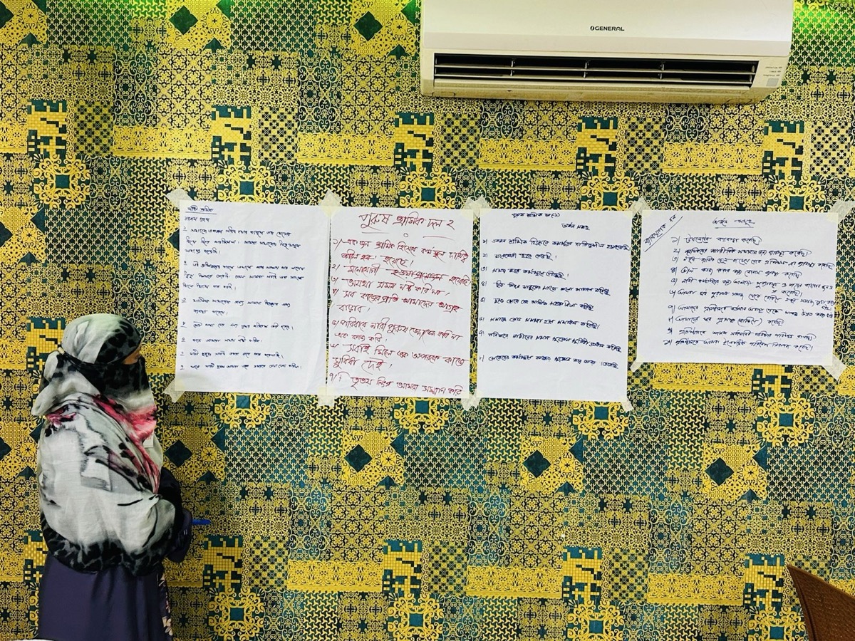 Participant reading research materials in Bangladesh